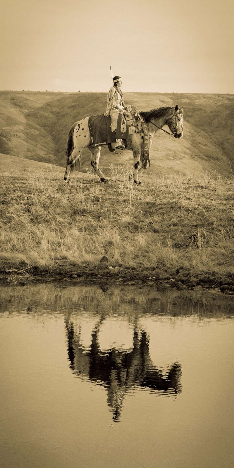 Riders moving across a grassland slope