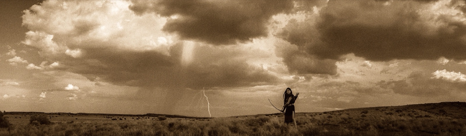 A lone archer beneath a lightning storm on the plains